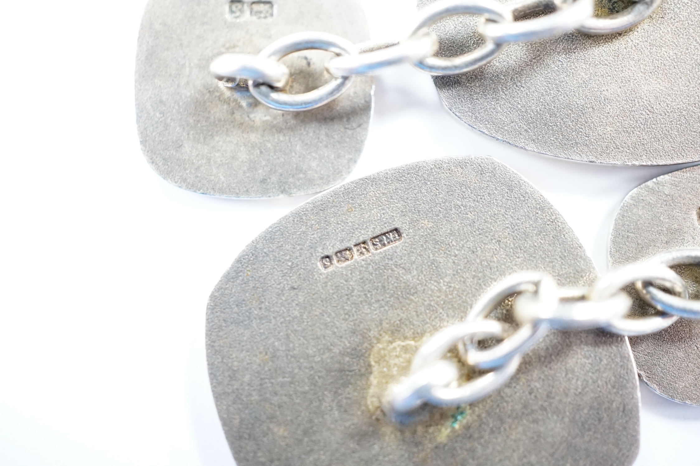 A modern pair of silver and red enamel cufflinks, embossed with the Order of The British Empire, by Toye, Kenning & Spencer, 19mm.